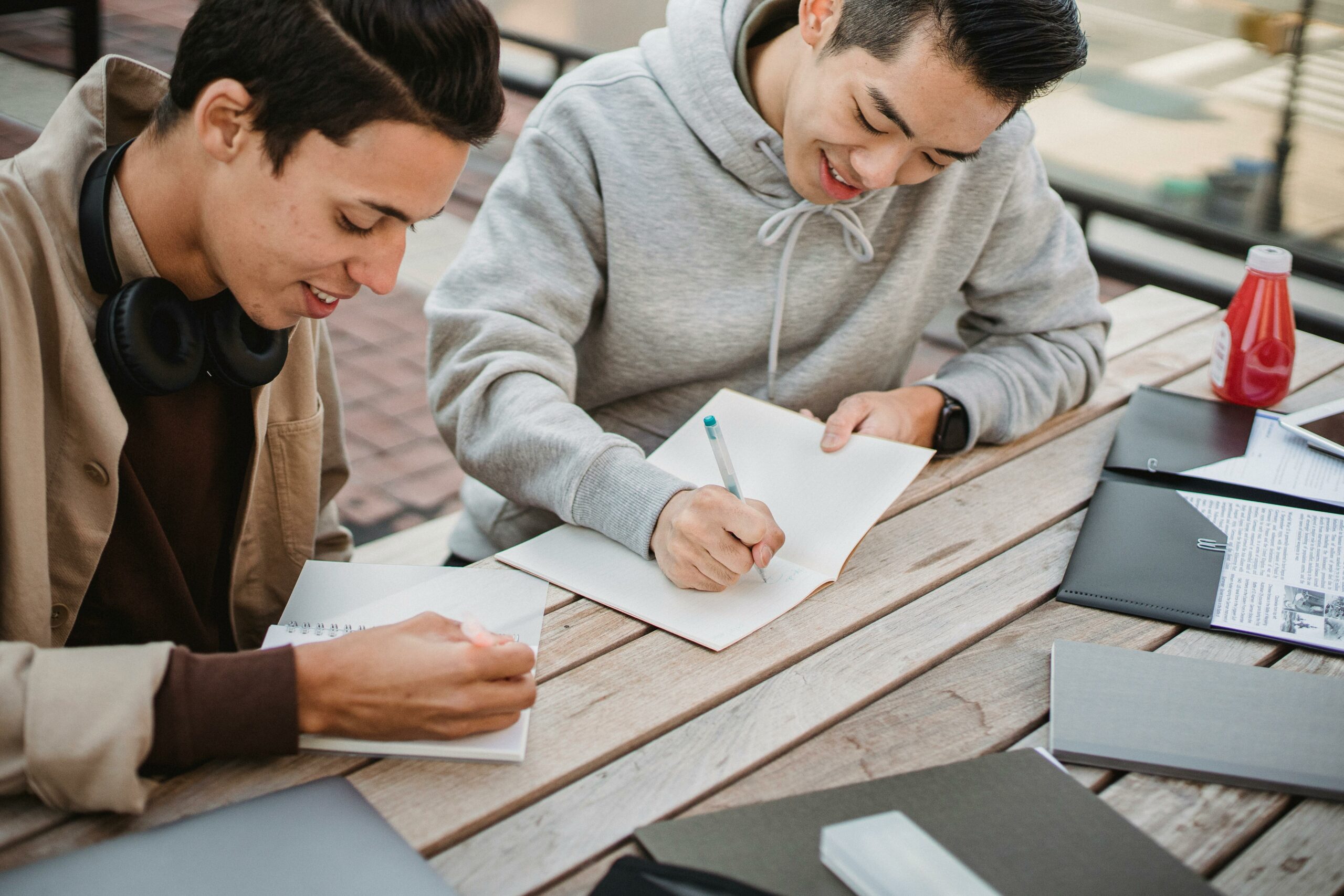 Image of two students preparing a thesis statement for an essay